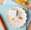 soft pink enamel flower-shaped trinket dish holding clips and small items