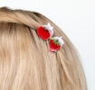 Set of two mini fruit-shaped hair claw clips in strawberry and apple designs.