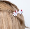 Set of two mini rabbit-shaped hair claw clips with white faces and pink ear details.
