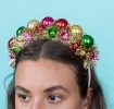 Festive tinsel party headband decorated with colourful jingle bells .