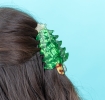 Green Christmas tree-shaped hair claw clip with a glittery gold star topper.