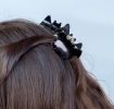 Set of two black glitter bat-shaped hair claw clips.