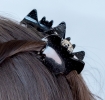 Set of two black glitter bat-shaped hair claw clips.