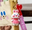 Bunny bag charm with pink outfit, silicone wrist strap and bow detail
