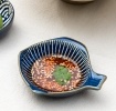 Fish-shaped blue ceramic dipping bowl shown with dipping sauce.