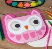 Pink owl-faced sketchbook with a carry handle, large eyes and orange beak.