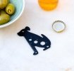 Dog-shaped multi-tool with ruler and wrench cut-outs.