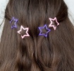 Purple and pink star hair clips in a set of four.