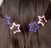 Purple and pink star hair clips in a set of four.