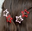 Red and pink star hair clips in a set of four.