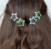 Blue and green star hair clips in a set of four.