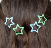 Blue and green star hair clips in a set of four.