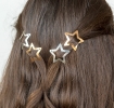 Gold and silver star hair clips in a set of four.