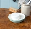 Round two-part soap dish with drainage holes in sage green.