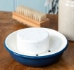 Round two-part soap dish with drainage holes in blue.