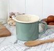Pistachio green enamel measuring jug with pour spout and 1 litre internal markings.