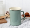 Pistachio green enamel jug with pour spout, white interior and 1.7 litre capacity.