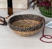 Round seagrass bowl with natural and black woven detail.