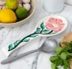 White ceramic spoon rest with blue fish design.