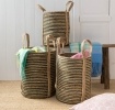 Set of three striped storage baskets with handles in assorted sizes.