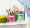 Decorative storage tins labelled "Spiced Tomatoes" and "Moroccan Lemons"