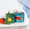 Decorative storage tins labelled "Pepper" and "Paprika" with illustrated peppers