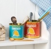 Decorative storage tins featuring vintage-style mango illustrations