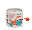 Farmyard‑themed winding music box with illustrated tractor and animals, featuring a red turning handle.