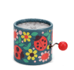 Winding music box with illustrated flowers and ladybird design, featuring a red turning handle.