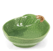 Green ceramic bowl with textured surface and a leaf design near the rim with brown stem accent