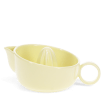 Yellow stoneware lemon squeezer with handle and pouring spout.