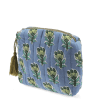 Blue quilted makeup bag with green and blue flowers.