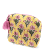 Yellow quilted cosmetic bag with a pink and green floral print and a pink tassel on the zip.