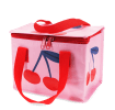 Pink insulated lunch bag with a bold cherry design and red handles.