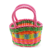 A small woven plastic basket with a pink handle and multicoloured striped body