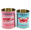 Two Ocean’s Brand storage tins featuring lobster and crab illustrations in pink and blue.