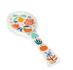 White ceramic spoon rest with a colourful fruit and leaf design.