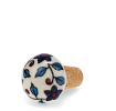 Ceramic and cork bottle stopper with floral and leaf pattern.