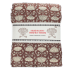 Brown hand block-printed throw with floral pattern, folded in packaging.