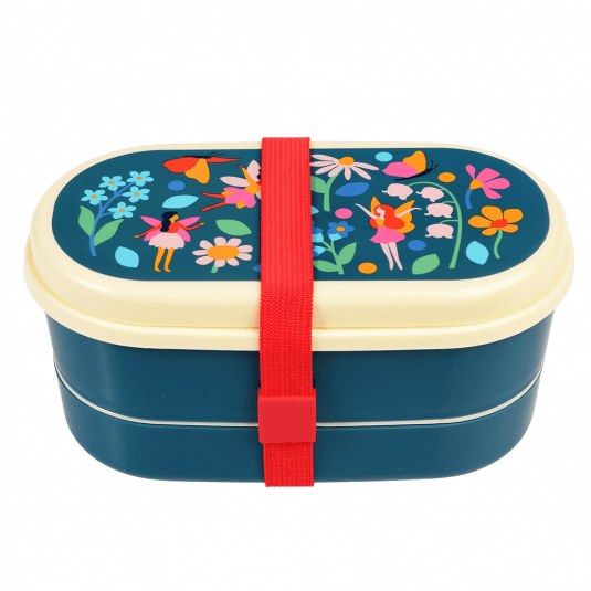 Dark blue kids bento box with cream lid and middle tray plus red elastic strap featuring print of fairies amongst flowers