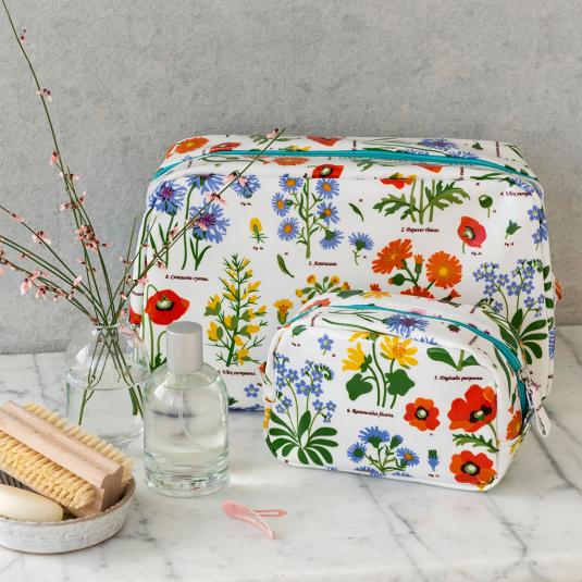 White oilcloth wash bag and makeup bag collection with wild floral pattern