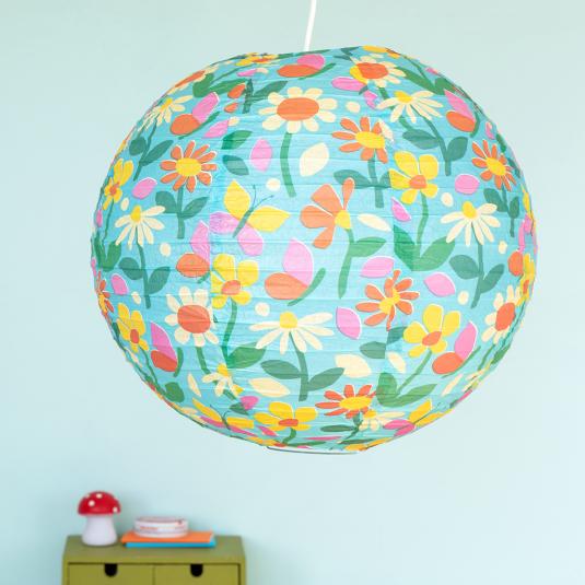 Light blue paper lampshade with butterfly and flower decoration installed in room