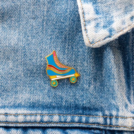 Roller skate pin badge attached to piece of clothing
