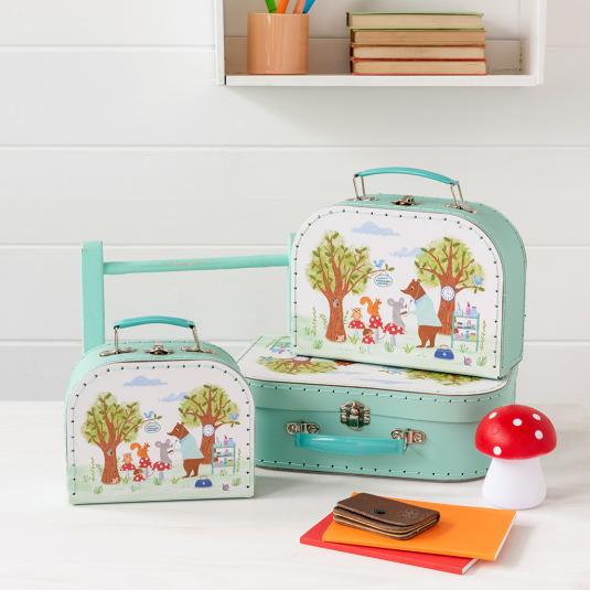 Woodland Friends storage cases with mushroom light, notebooks and wallet on table