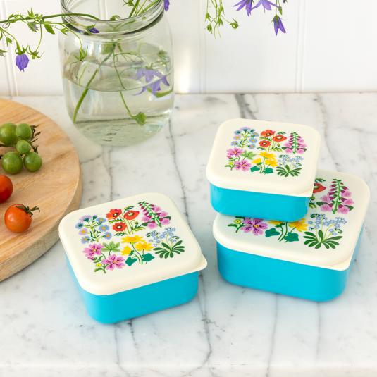 Three plastic snack boxes in turquoise and cream featuring floral pattern