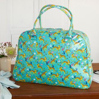 Turquoise oilcloth weekend bag with print of cheetahs