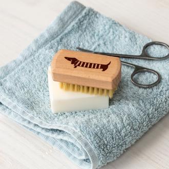 wooden nail brush featuring a sausage dog illustration