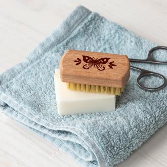 wooden nail brush featuring a butterfly illustration