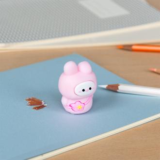 pink bunny shaped pencil sharpener with coloured pencils placed beside