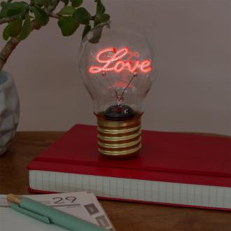 Love usb light bulb placed on a book with light on